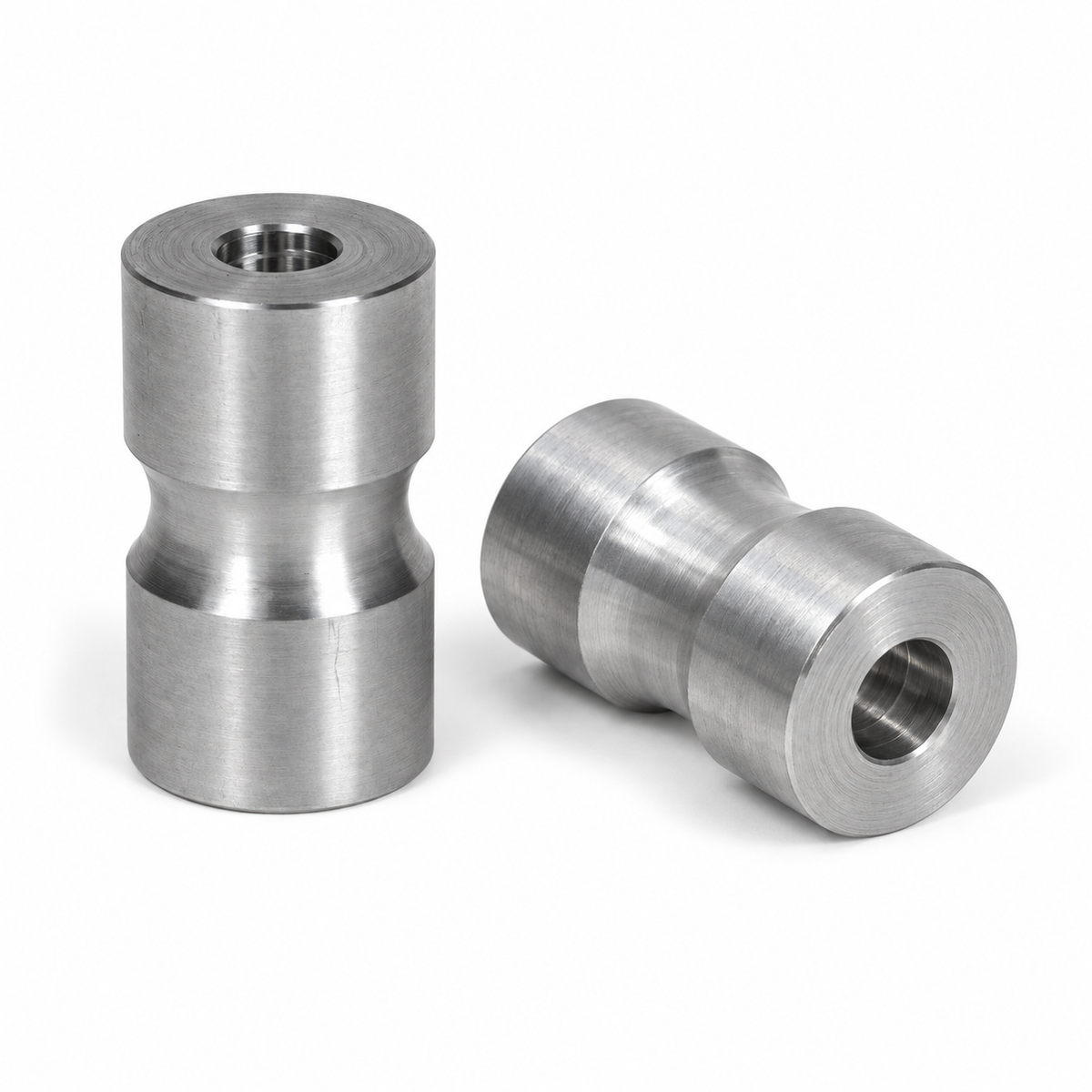 Pair of J Fab machined welding spacers on white background