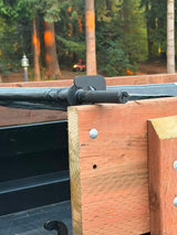 Close view of the tarp bar resting in a J Fab bracket at wooden sideboard height