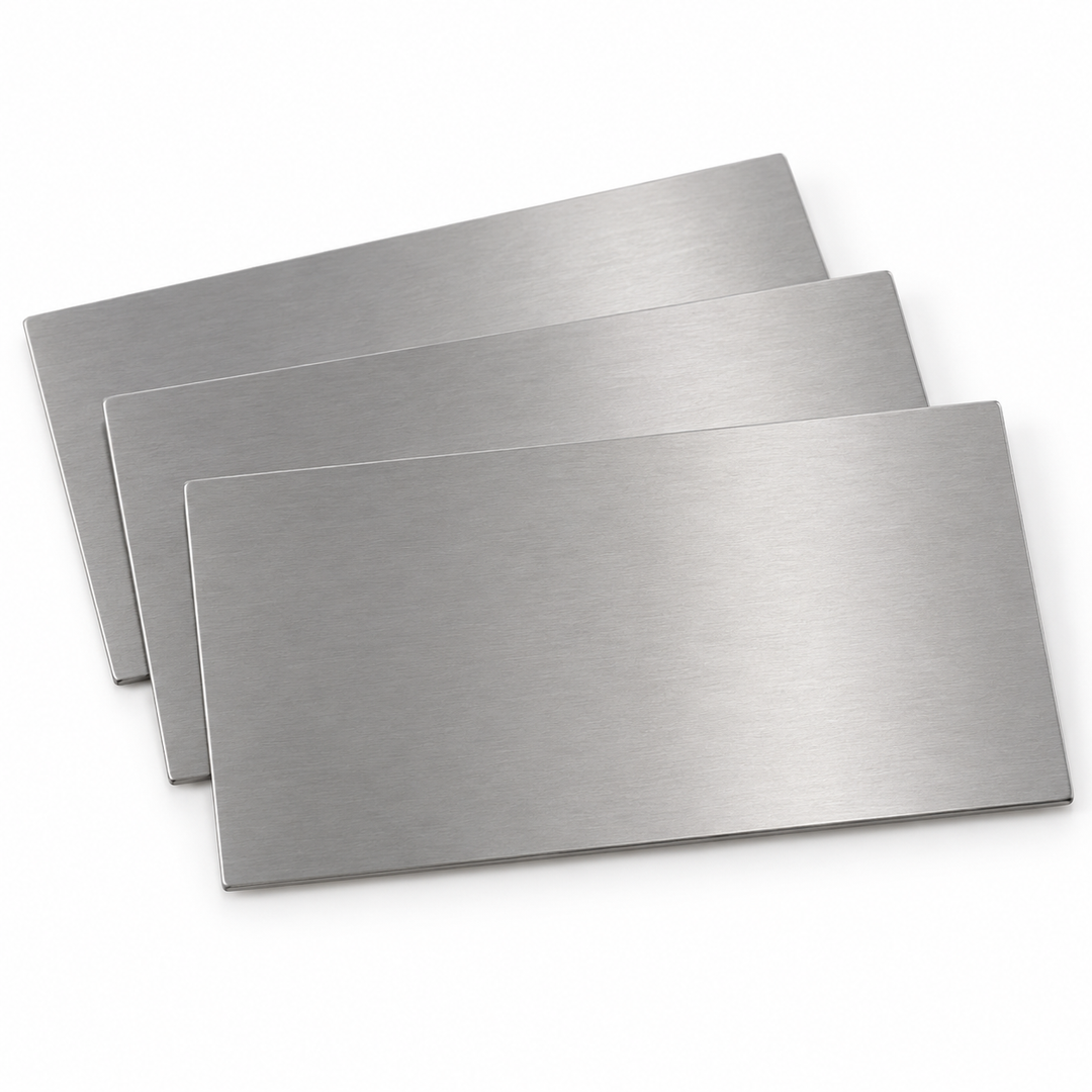 Product visualization — bare stainless steel business card blanks, 3½ × 2 in, no holes