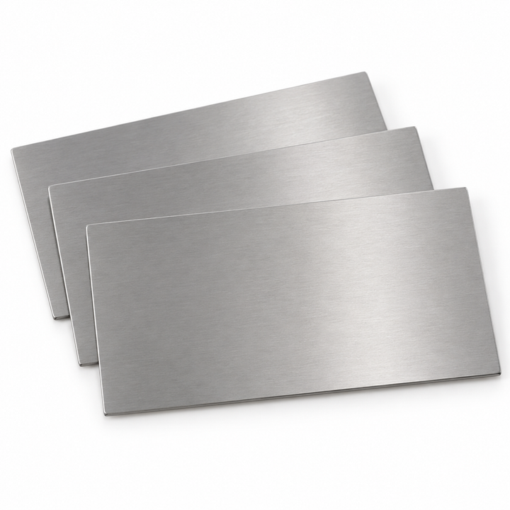 Product visualization — bare stainless steel business card blanks, 3½ × 2 in, no holes