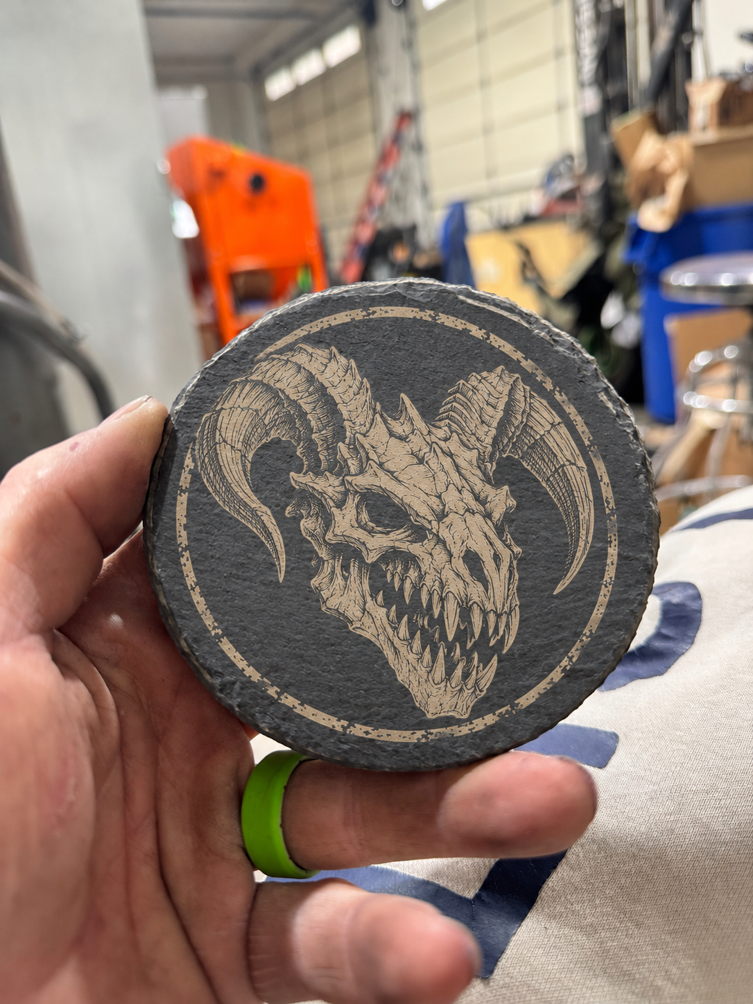 Deathclaw design on round charcoal slate with tan engraving