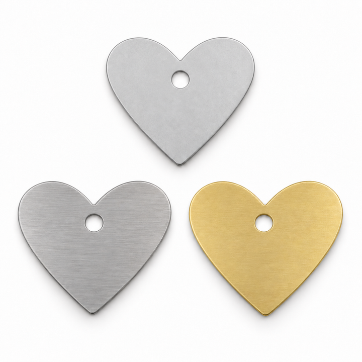 J Fab heart blank design render: centered single hole in bare aluminum, stainless steel and brass. Not manufactured-stock photography.