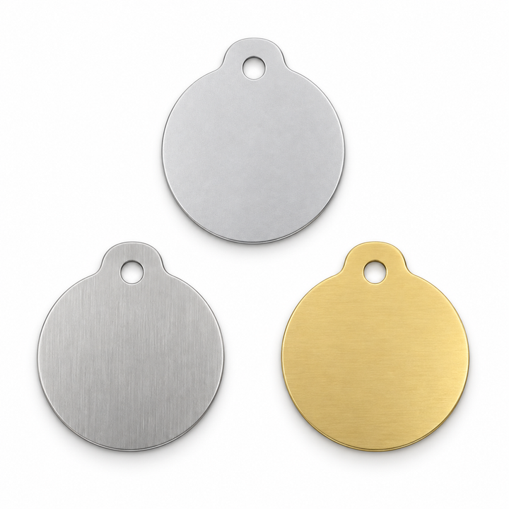Design render — bare aluminum, stainless steel and brass round-pet tag blanks, one hole; not manufactured stock.