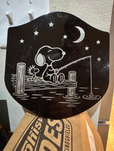 Finished black metal fishing plaque with Snoopy and Woodstock on a dock under the moon